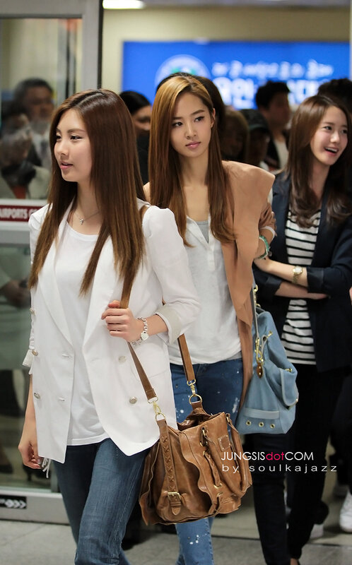 three women walking in airport