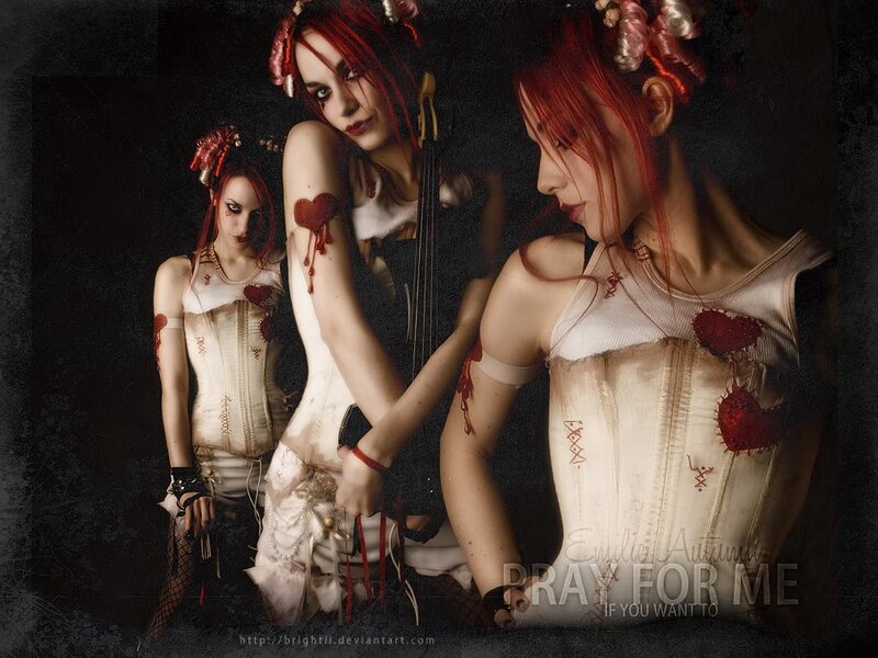 three women with red hair and corsets