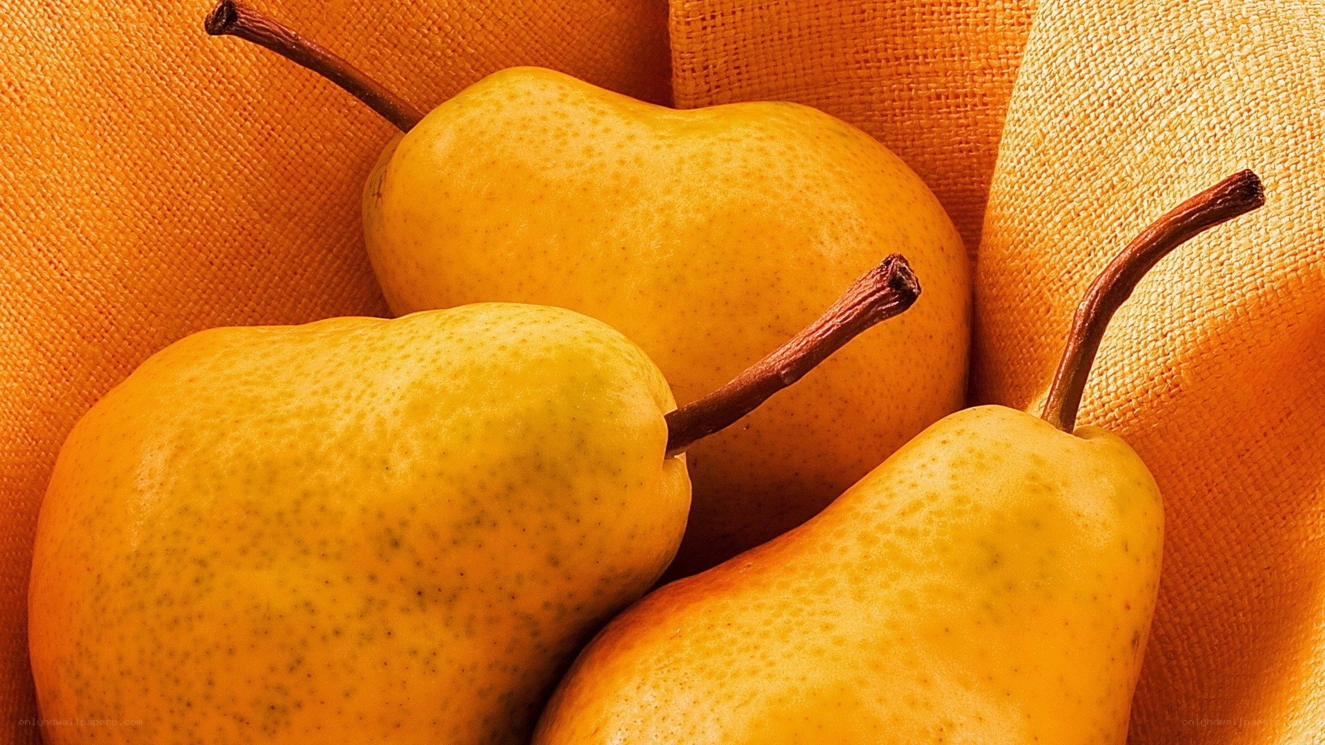 three yellow pears in a basket