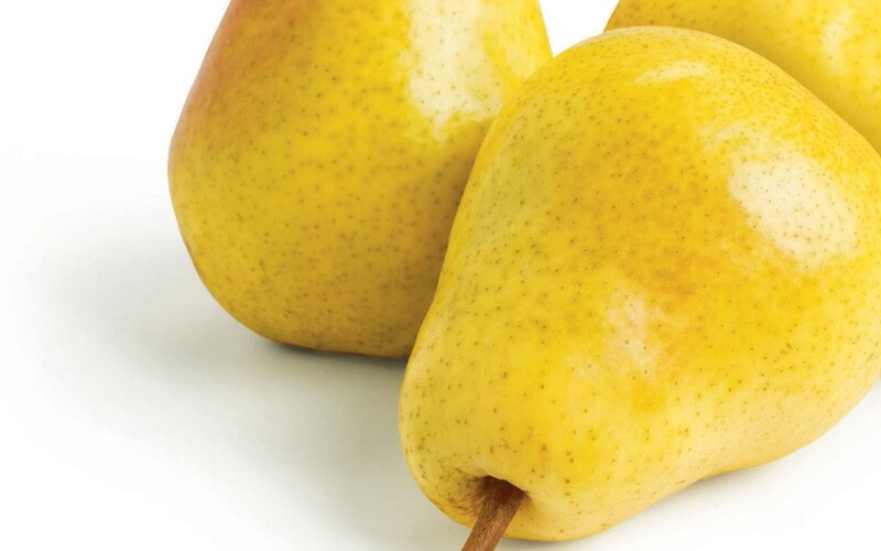 three yellow pears on white
