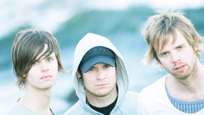 three young men by the water