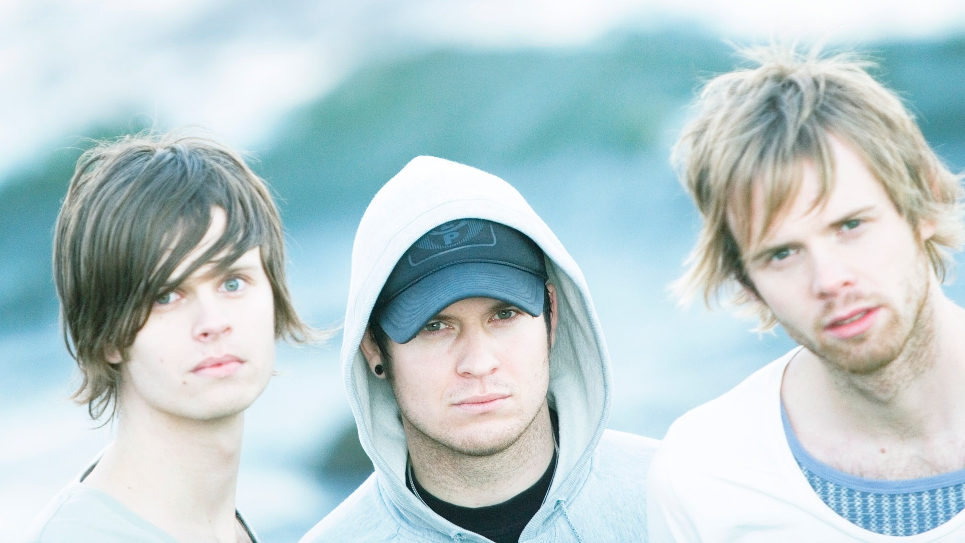 three young men by the water