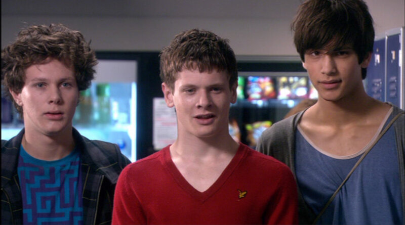 three young men in a school hallway