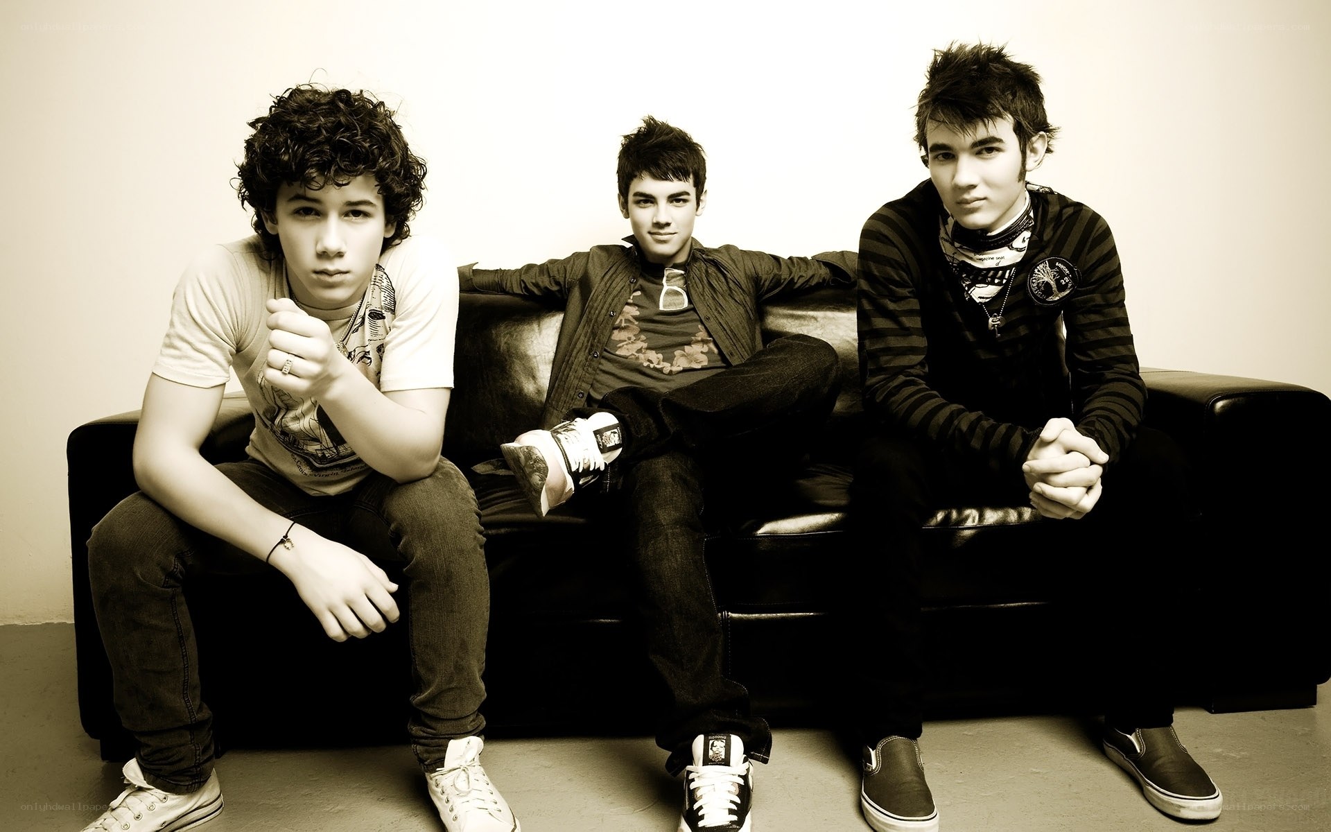 three young men on a couch