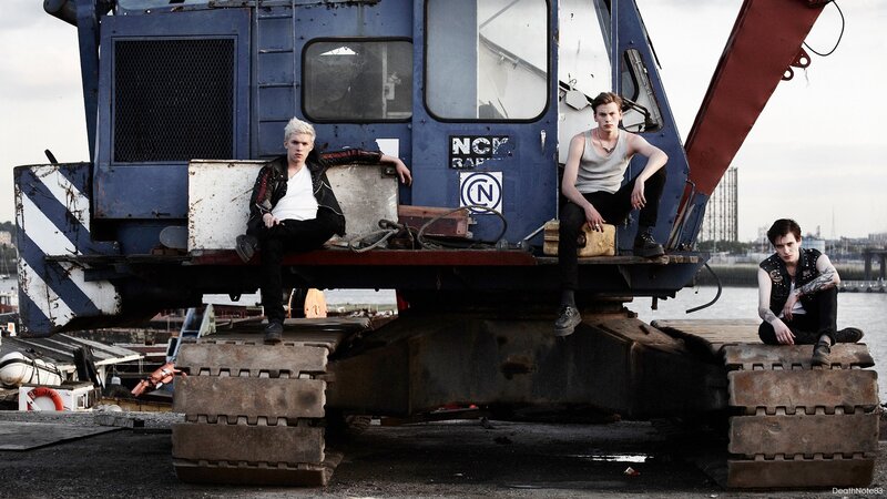 three young men on a crane