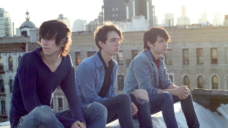 three young men on a rooftop