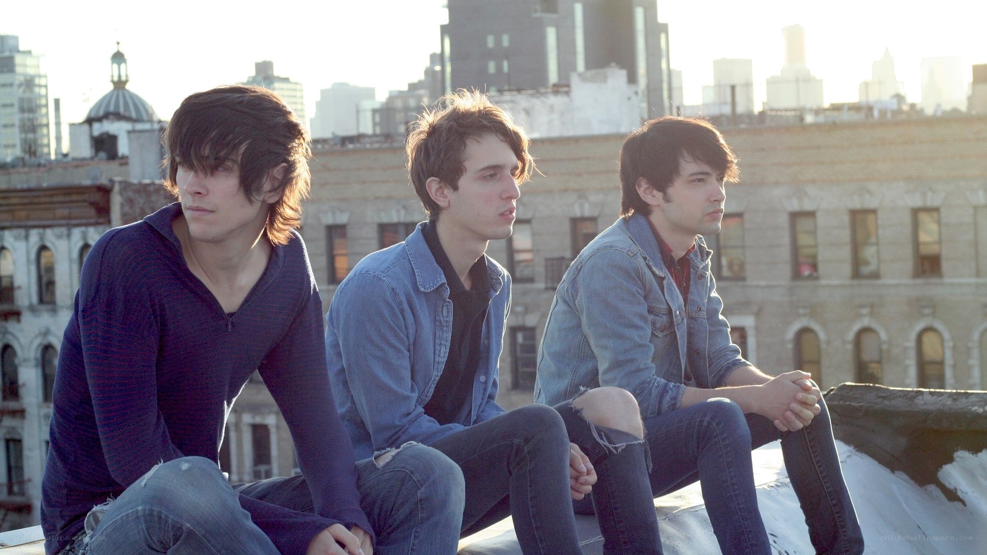 three young men on a rooftop