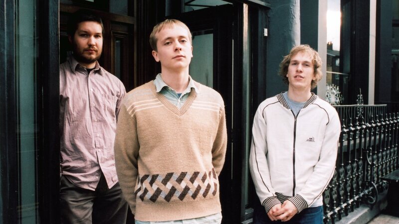 three young men standing outside