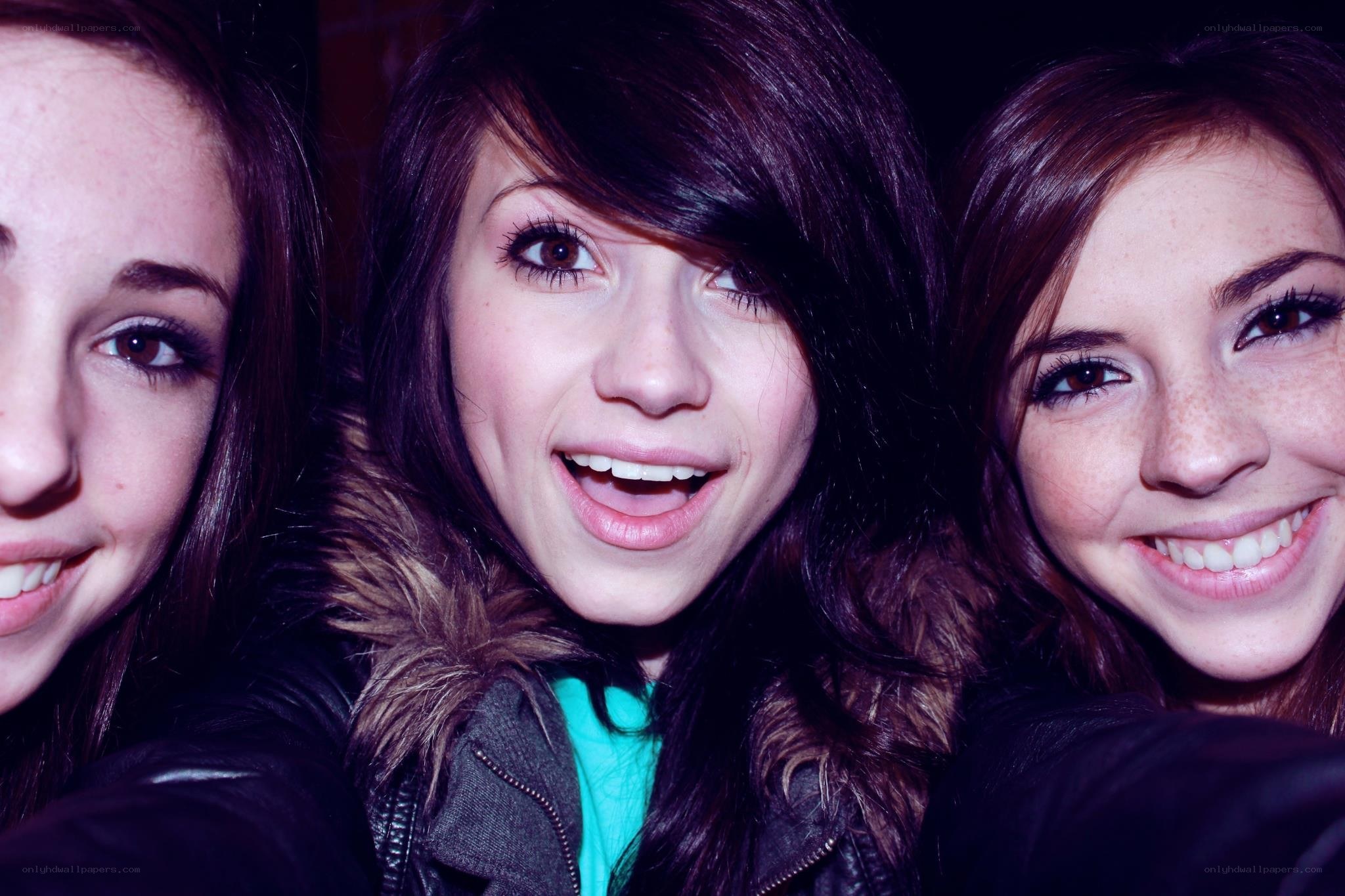 three young women smiling together