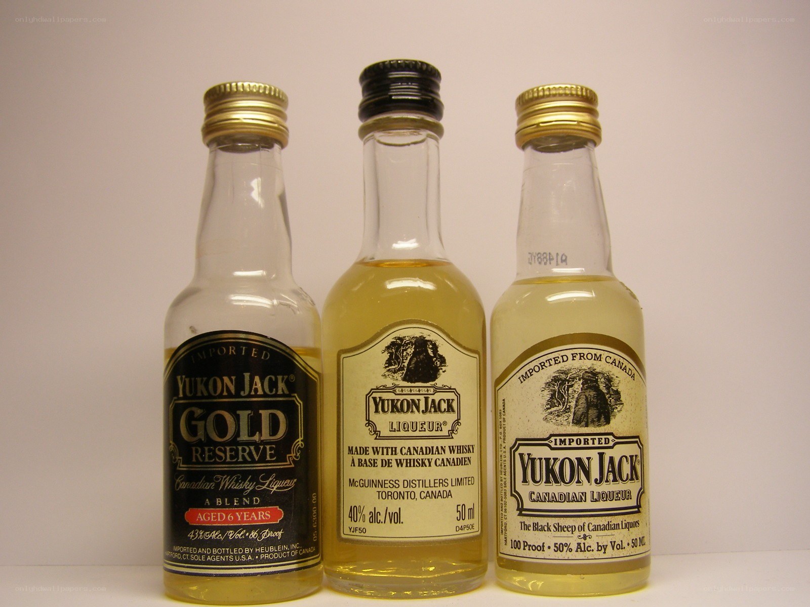 Three Yukon Jack liquor bottles