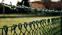 Barbed wire fences wires blurred background