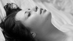 Black and white woman beds monochrome brunettes lying down