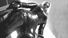 Black and white woman latex bondage