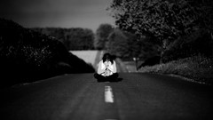 Black and white woman roads sitting depth of field
