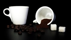 Black background beans coffee cups sugar cubes