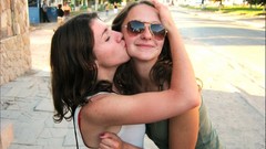 Brunettes woman kissing sunglasses