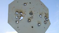 Bullet holes stop signs