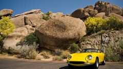 Car yellow cars vehicle rock rocks clear sky daylight shrubs
