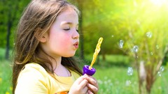 Children bubbles sunlight long hair blowing bubbles