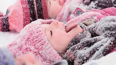 Children lying snow girl