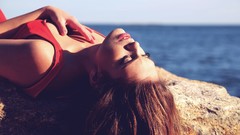 Coast woman red dress closed eyes brunettes lying down
