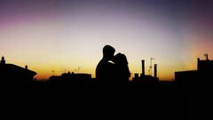 Couple buildings kissing darker afternoon