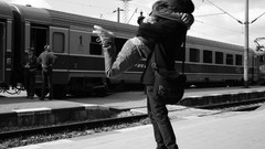 Couple monochrome lovers hugging vehicles grayscale trains 