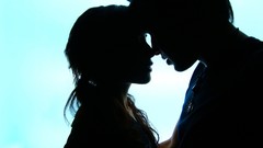 Couple silhouettes kissing