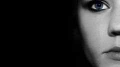 Dark eyes woman tears black background faces blue eyes 