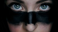 Dark woman paradise close-up stripes blue eyes face paint