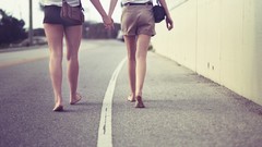 Feet barefoot holding hands