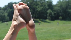 Feet woman outdoors soles legs up