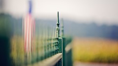 Flags American Flag fences blurred background depth of field