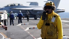 Flight yellow Aircraft Carrier deck sailor standing aircraft 