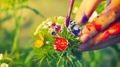 Flowers leaves paint hands multicolor blurred background paint 