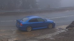 Fog blue Mountains cars roads Subaru vehicles rear angle view 