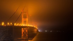 Fog night lights San Francisco Bridges