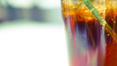 Glass bubbles coca-cola straws blurred background