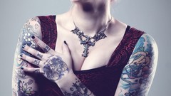 Gothic woman cross close-up red dress tattoos