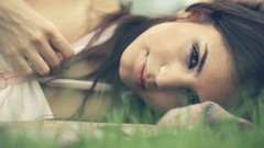 Grass woman brunettes laying on side