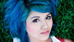 Grass woman faces blue hair piercings lying down