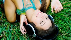 Grass woman headphones braid smiling closed eyes brunettes