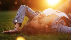 Grass woman outdoors sunlight brunettes lying down