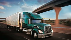 Green Volvo trucks freeway
