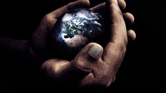 Hands black background Earth