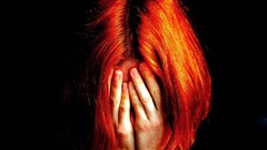 Head hands black background redheads