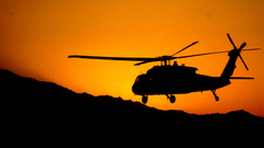 Helicopters silhouettes vehicles sunset