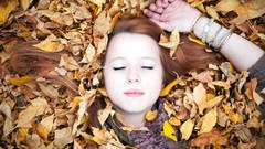 Leaves autumn woman closed eyes lying down redheads