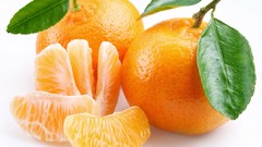 Leaves oranges white background slices fruits
