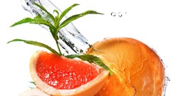 Leaves water white background slices fruits grapefruits